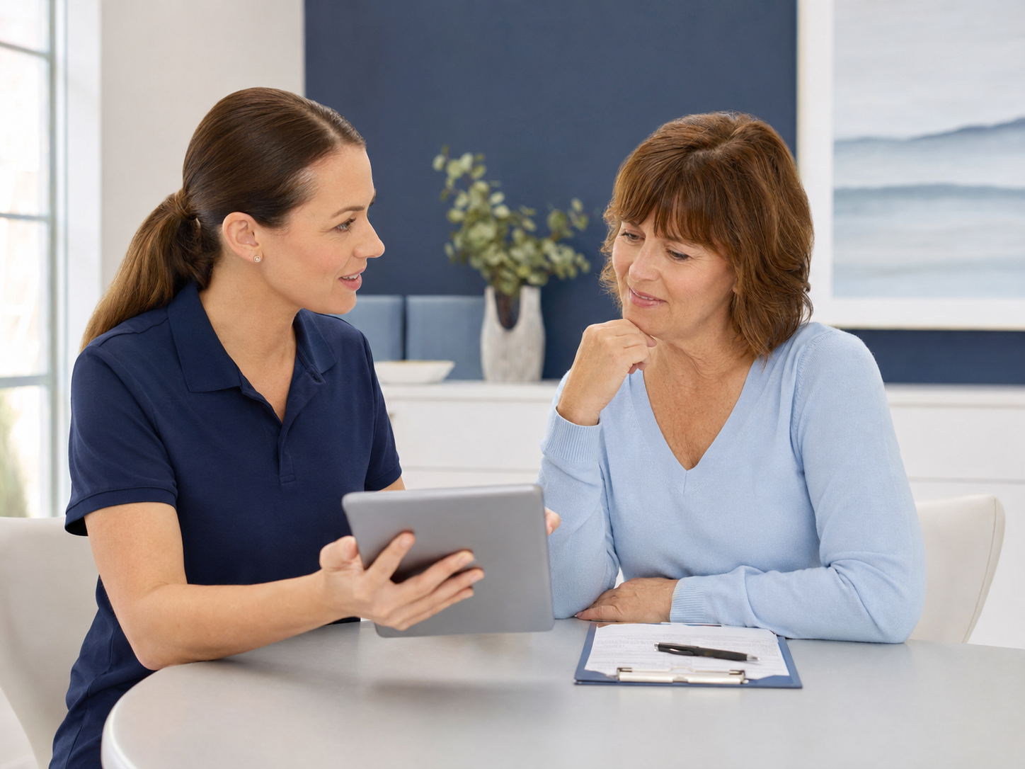 A physical therapist consulting with a patient about her rehabilitation goals